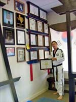 Master Gary White poses shows off some of his certificates.